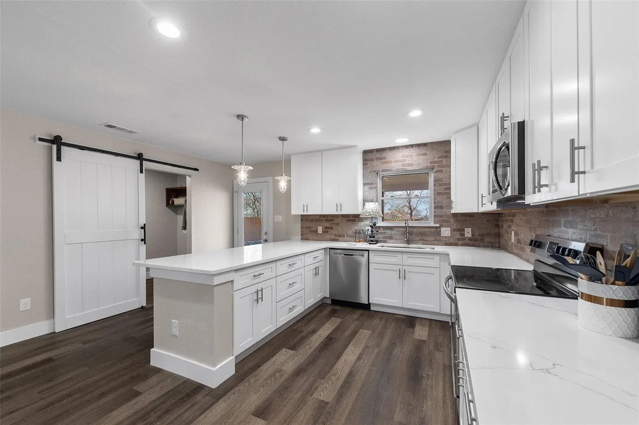 White kitchen with barn door pantry